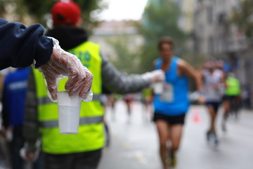 Water station help for runners in a city marathon