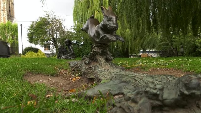 the statue of the rabbit from "Alice in Wonderland" in a park