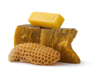 How to get natural organic beeswax. Pieces of organic beeswax on a white background. The use of...
