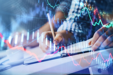 Multi exposure of two men planing investment with stock market forex chart.