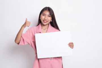 Fototapeta premium Young Asian woman show thumbs up with white blank sign.