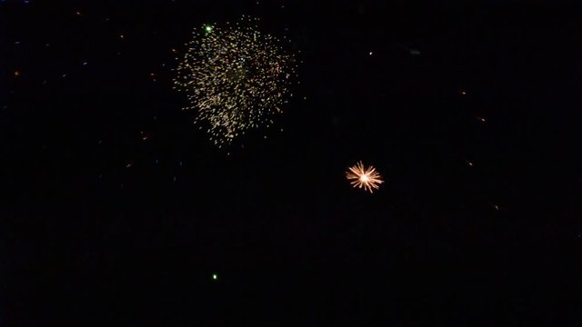 Colorful fireworks that explode and fill the darkness of the night sky with colored light.