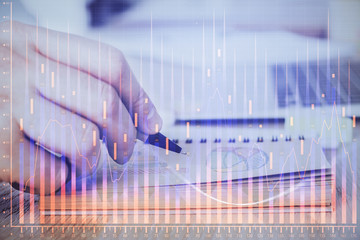 Multi exposure closeup hands with stock market forex graph.
