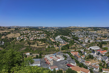 Picturesque view of Saint-Flour (Sant Flor) lower town. Ander and Margeride mountains in the background. Saint-Flour, Cantal department, Auvergne region, France.