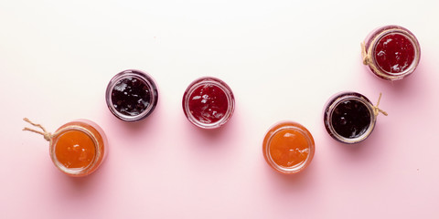 A glass of mixed berry jam with strawberries, bilberries, red currants, raspberries and blackberries