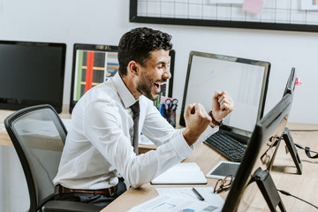 happy bi-racial trader showing yes gesture with closed eyes