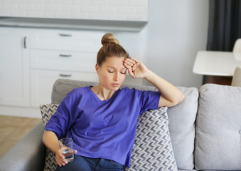 Portrait of young woman suffering from ache.