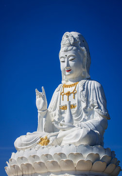 Big guanyin statue with blue sky background.