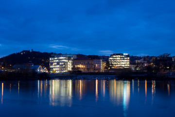 Obraz premium Night city landscape and panorama in the bright evening lights of the Czech capital Prague overlooking the Vltava River.