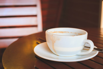 Empty coffee cup after drink on wood table.