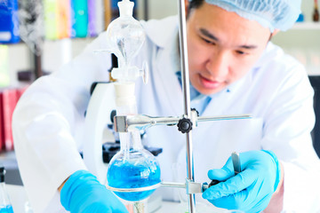 Male scientist and laboratory experiment