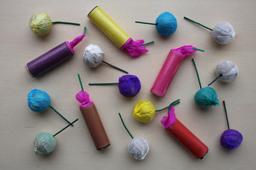 Different colored pyrotechnic products, firecrackers and smoke bombs, in a chaotic position.