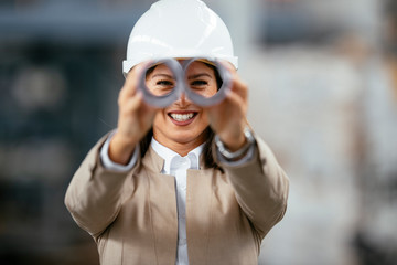 Portrait of funny businesswoman. Female architect having fun at work in factory. 