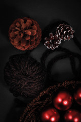 Naklejka premium Pines and ornaments in a wooden knitted basket.