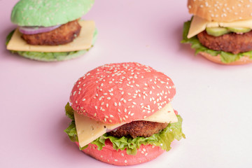 Big and juicy beef meat with cheese and vegetables in the colorful ban.