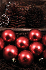 Pines and ornaments in a wooden knitted basket.