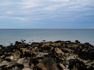 Fototapeta na wymiar A Horizon and Sea and Exposed Rocks