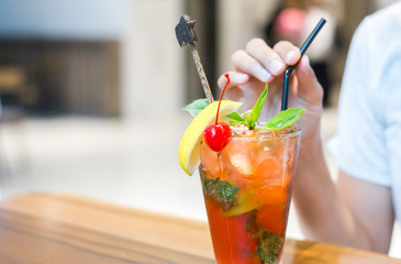 lemon, ice, tube and mint in mocktail on the table.