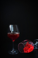 Red pomegranate wine in a wine glass and pomegranate seeds