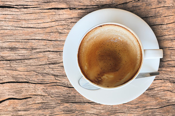 Empty coffee cup after drink foam in white cup on old wooden table