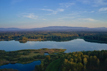 Peaceful aerial shot of a lake with mountain in distance