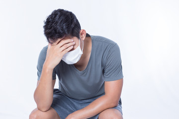 A man is sick and wear hygienic mask and headache.