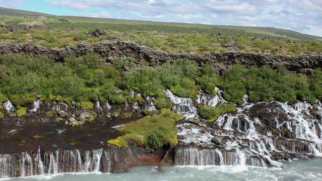 Hraunfossar waterfall in Hallmundarhraun lava field deversing into Hv&iacute;t&aacute; river in Iceland.