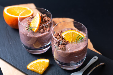 Healthy food concept Chia chocolate orange pudding with granola and pumpkins seed topping in the glasses