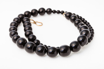 coiled necklace from polised jet stone on white