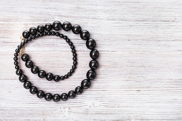 top view of jet stone (gagate) necklace on gray