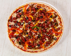 Pizza with sausages and minced meat
