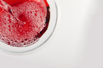 Glass of red wine with shadow.Top view. Abstract red wine bubbles.