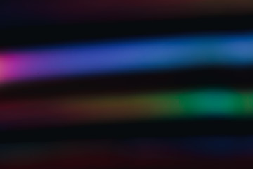 Holographic background with different colors. Holographic lines on black background. Neon lines.