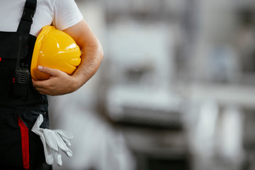 Close up of worker holding helmet