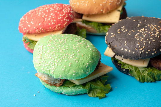 Four fashionable multi-colored small burgers. Vegan meal