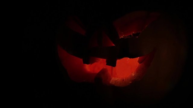 Halloween pumpking candles glowing in the dark