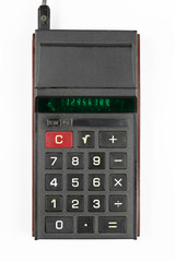 old Soviet calculator with luminous green LEDs numbers on a white background, view from the top