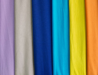 A group of coloured matted fabrics, a palette of textiles.