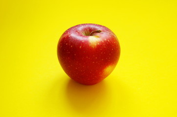 Red Fresh Apple on yellow background, diet and healthy lifestyle concept