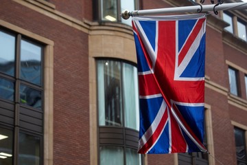 The Union jack hangs from a flagpole in London