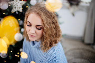 Beautiful woman at Christmas tree