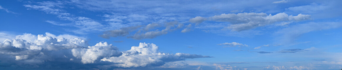Naklejka na ściany i meble Summer sky and clouds. Panoramic photo, August, rainy season, atmospheric phenomena.