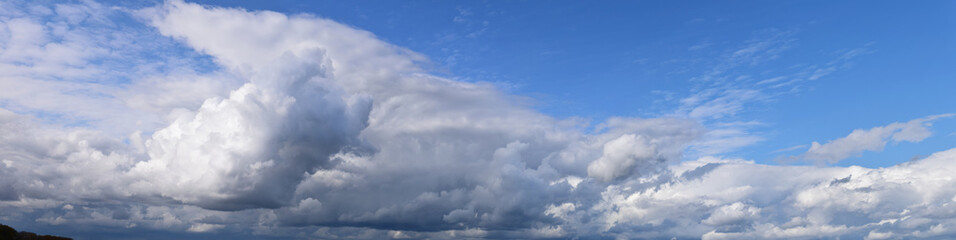 Summer sky and clouds. Panoramic photo, August, rainy season, atmospheric phenomena.