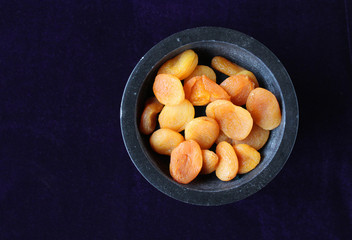 Dried apricots flat lay dark background