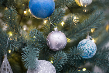 Obraz na płótnie Canvas Silver, gold balls on Christmas tree in artificial frost. New Year and Christmas otribut for greeting cards or congratulations. Background fairytale atmosphere, idea decorating house for holiday.