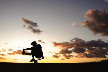 Silhouette of a man on balance board on sea shore