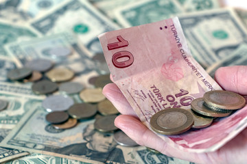 Turkish lira TRY coins and banknotes against american dollar banknote background