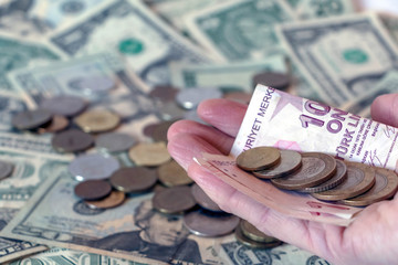 Turkish lira TRY coins and banknotes against american dollar banknote background