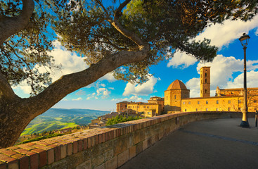 Tuscany, Volterra town skyline, church and trees on sunset. Italy