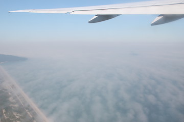 wing of an airplane flying above the clouds
